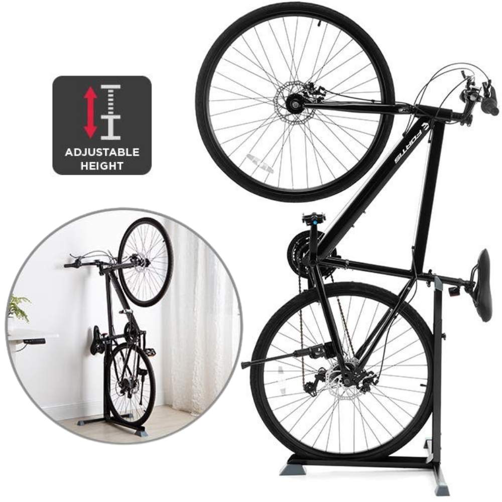A bicycle hanging vertically from a wall holder in a narrow hallway
